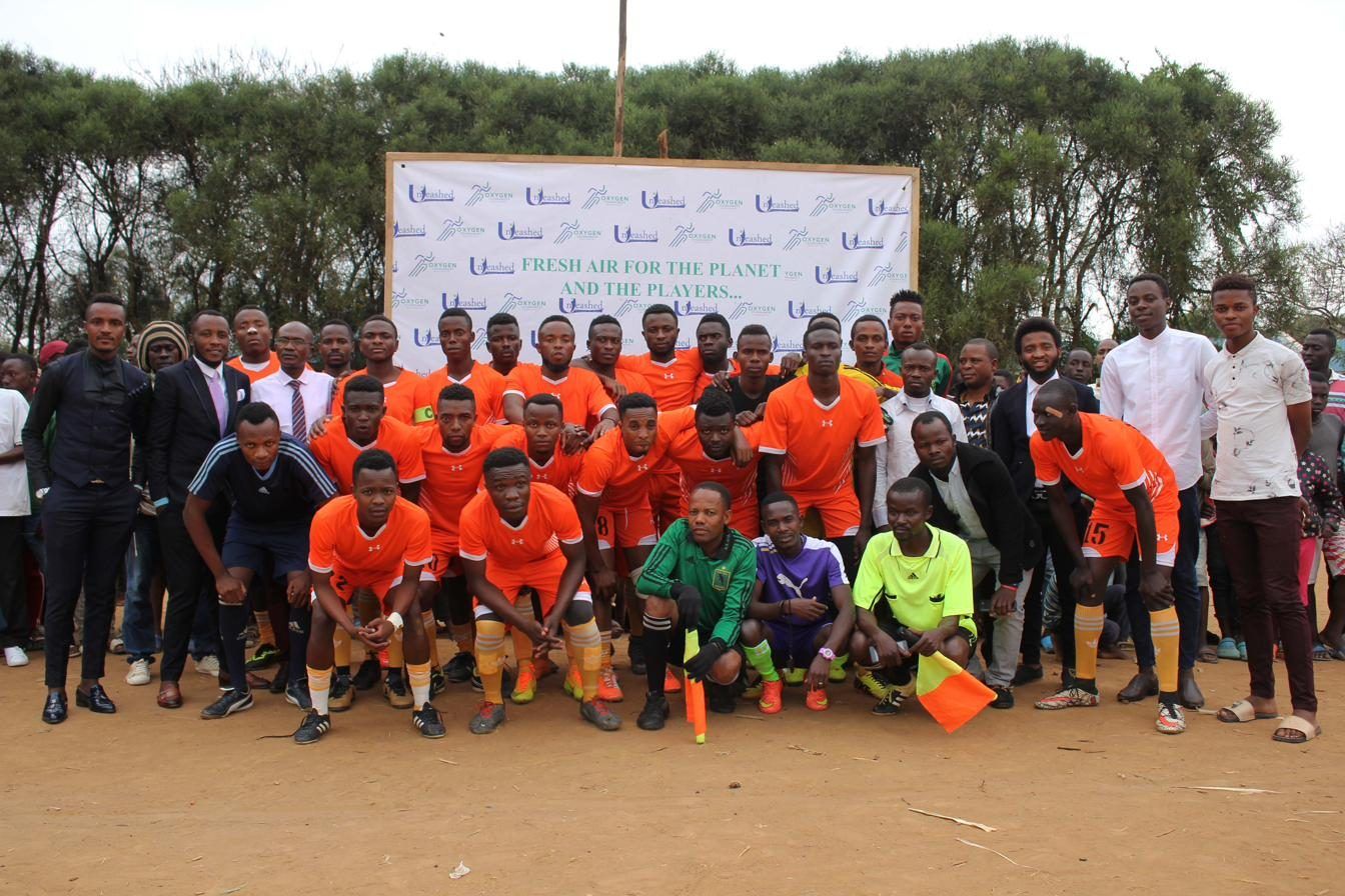 Football teams gathered for a Fount Tournament group photograph